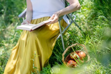 Güvertede kitap okuyan yaşlı kadın.