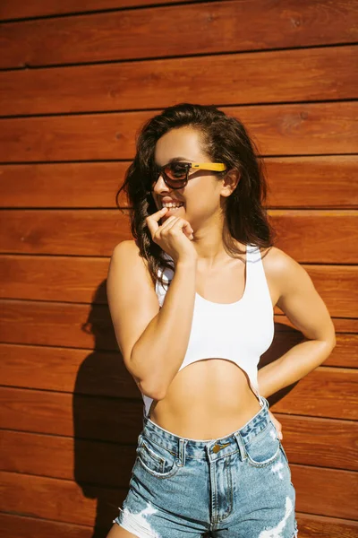 Beautiful brunette girl in shorts looking flirty — Stock Photo, Image
