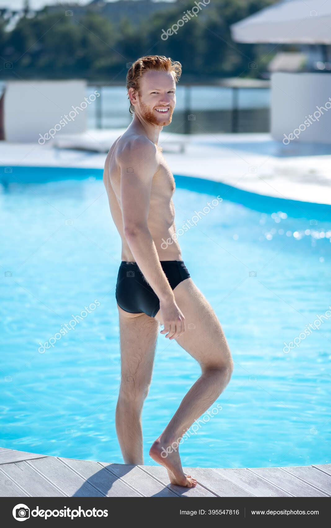 Tall athletic man turning back near the pool. Stock Photo by