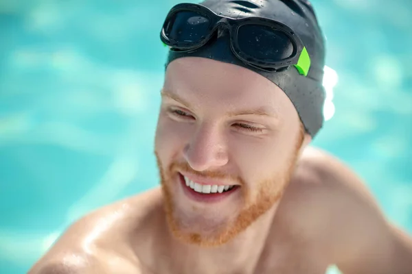 Smiling face of man in swimming cap and glasses — Stock Photo, Image