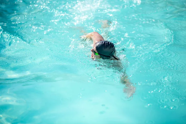 Man swimming forward on his side in pool — Stock Photo, Image