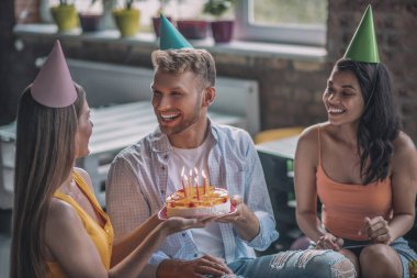 Üç neşeli arkadaş birlikte doğum günü partisi veriyor.