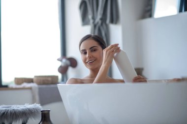 Banyo yapan ve mutlu görünen bir kadın.