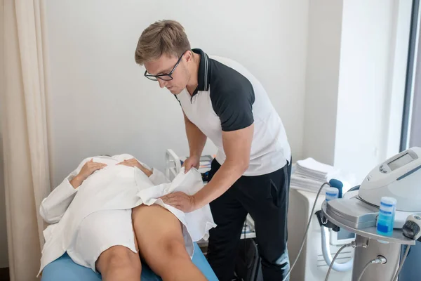 Doctor checking his patients bones and muscles