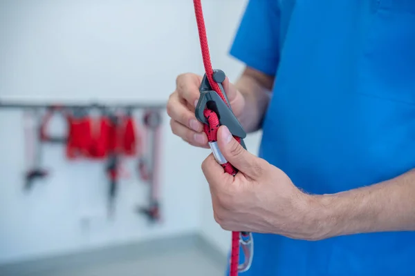 Mãos de homem de uniforme médico segurando equipamento médico. — Fotografia de Stock