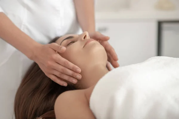 Professional doing face massage to a customer — Stock Photo, Image