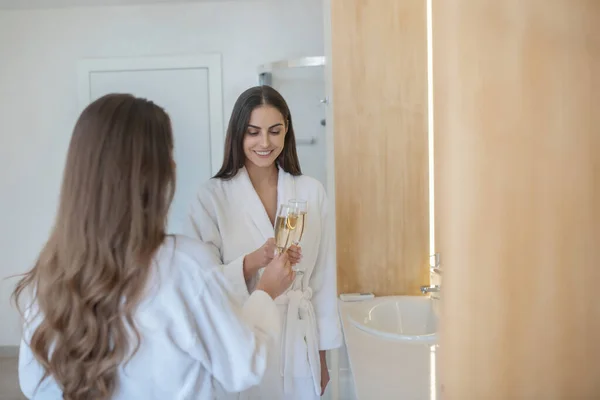 Dos chicas guapas pasando tiempo juntas y bebiendo champán — Foto de Stock