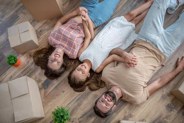 Genç bir aile yerde yatıyor ve dinleniyor. — Stok fotoğraf