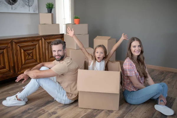Cute young family feeling great after move to new house — Stock Photo, Image