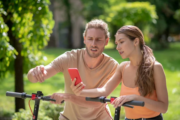 Pareja joven mirando algo por teléfono — Foto de Stock