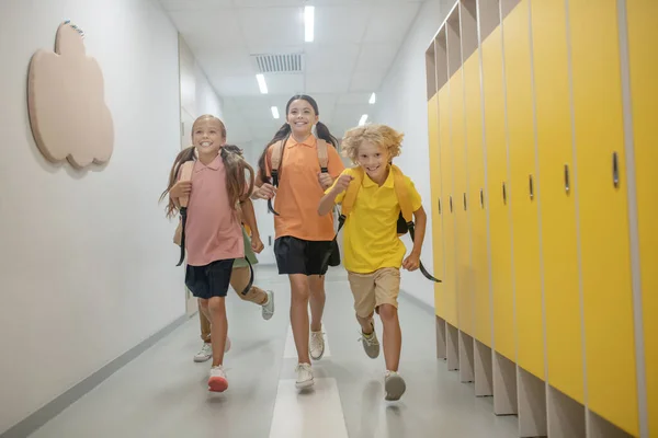 Escolares correndo no corredor da escola depois das aulas — Fotografia de Stock