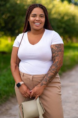 African American female enjoying leisure walk in natural green park