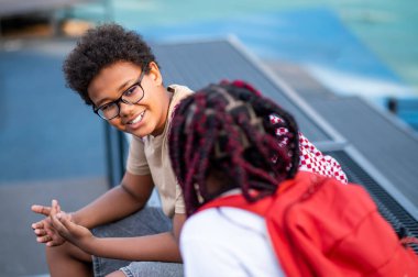 At the playground. Two teens at the playground looking contented and relaxed