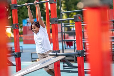 Happy girl. Girl playing at the playground and looking happy and energized