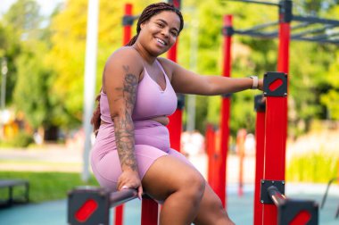 Confident woman with curvy figure and natural beauty in pink activewear