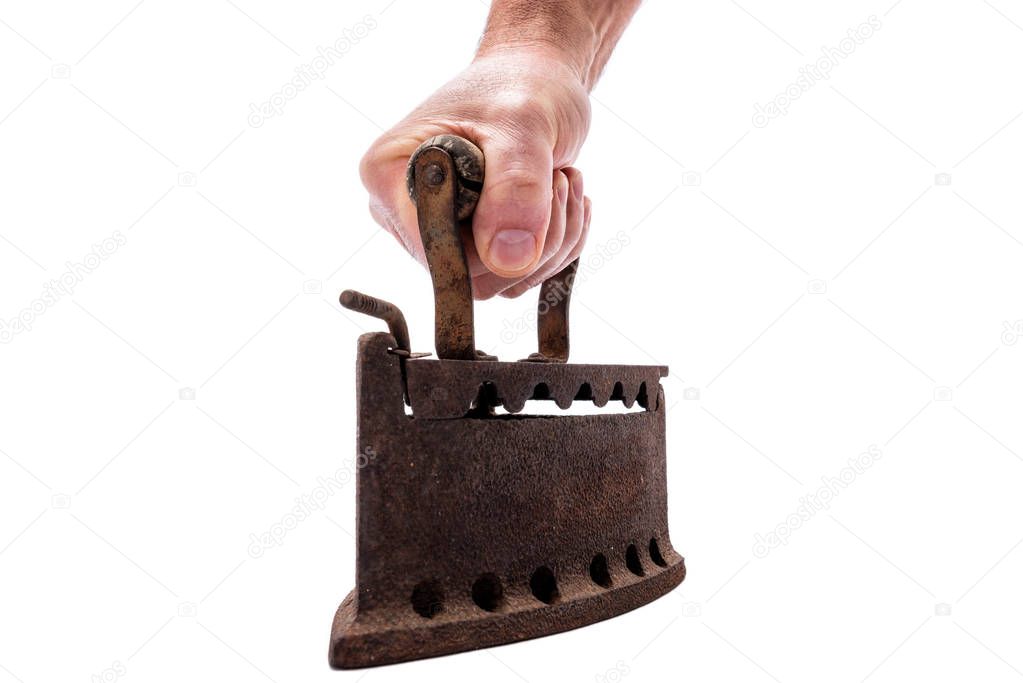Hand holds old rusty iron on a white background. Ironing