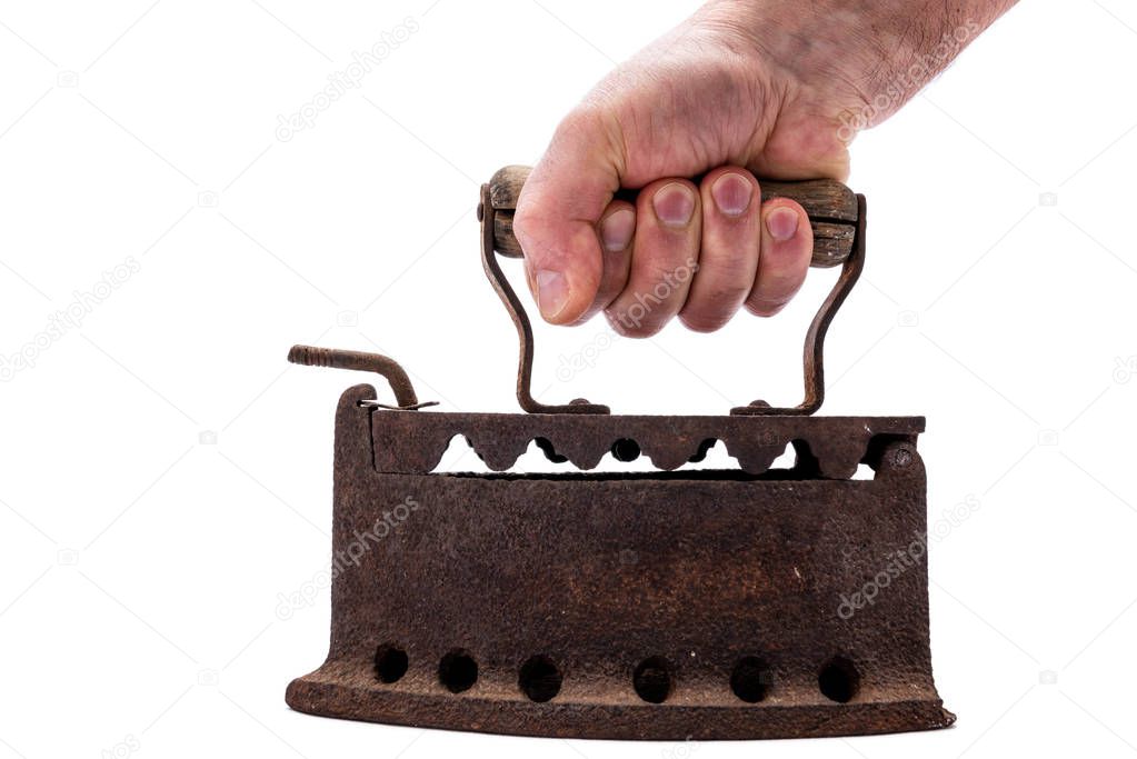 Hand holds old rusty iron on a white background. Ironing