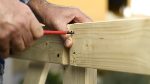 Adult Carpenter Craftsman Screwdriver Unscrews Screw Boards Wooden Fence Housework — Stock Video