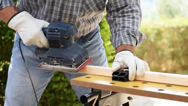 Close Carpenter Dengan Tangan Terlindungi Oleh Sarung Tangan Dengan Sander — Stok Video