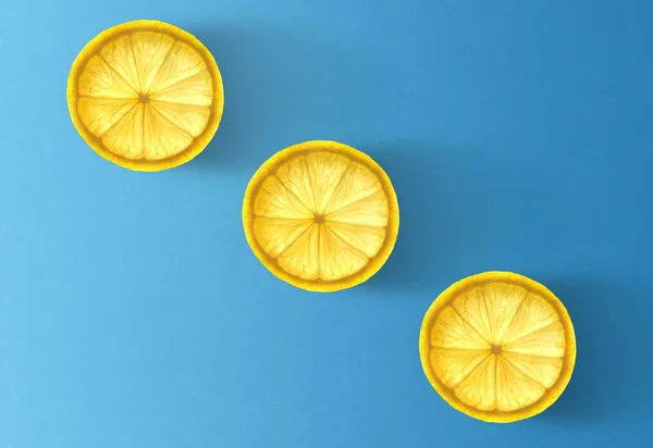 dry lemon slices on blue background, minimalism concept