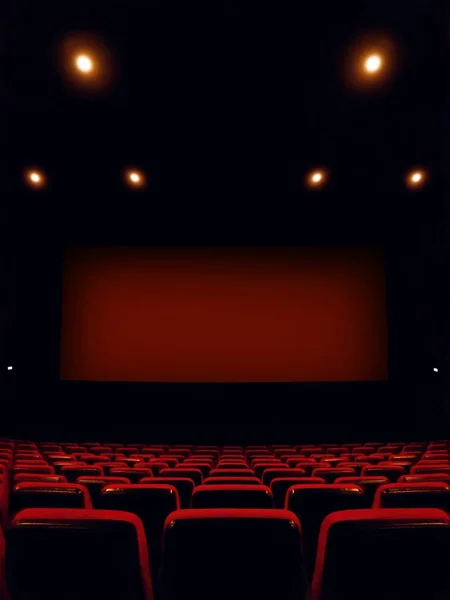 cinema interior with screen and red seats