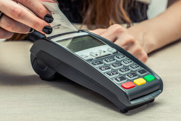 Credit or debit card password payment. Customer hand is entering personal identification number in shop or supermarket. Payment terminal keypad, pin.  Buy and sell products and service. Close-up, selective focus.