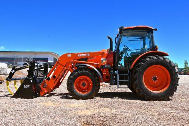 RAPID CITY, SOUTH DAKOTA, May 23, 2018:  The Kubota tractor and loader are  products of Kubota Corporation based in Osaka, Japan, established in 1890. clipart