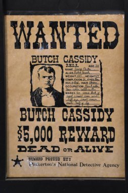 BONANZAVILLE, NORTH DAKOTA, August 17, 2018: A Butch Cassidy wanted poster is displayed in the old jail building during Pioneer Days held each August at Bonanzaville. clipart