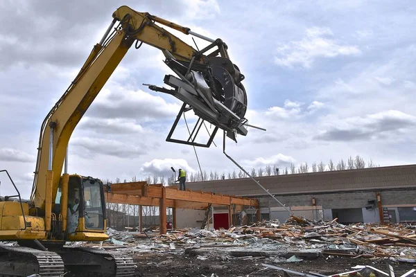 Bir kazı makinesinin çeneleri bir yıkım projesinde bir yük hurda metal kapmak almak.