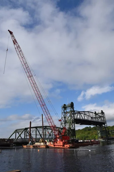 A lift bridge is in repair with a crane in place for construction activity.