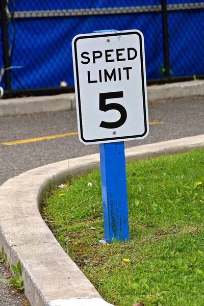 The driving speed limit around a curve is 5 mph. 