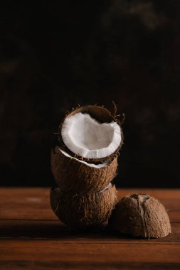 Koyu ahşap arka plan üzerinde kırık hindistancevizi yığını