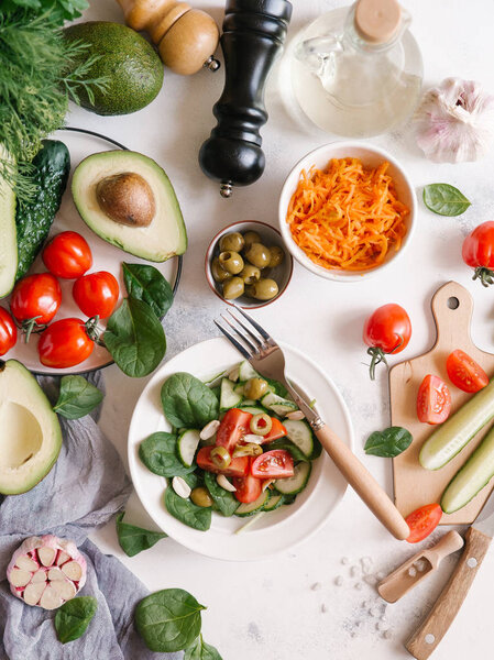 Top view of fresh vegetable salad on white plate