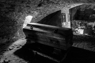 Inside view of crypt with old coffin clipart