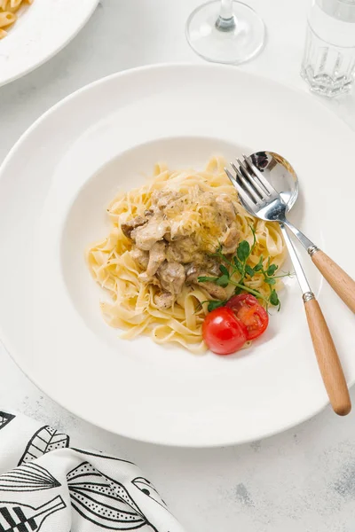 Beyaz tabakta et sos ve parmesan peynirli makarna