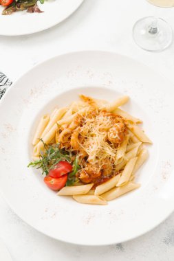 Beyaz tabak içinde sığır eti ve parmesan peynirli taze makarna üstten görünüm