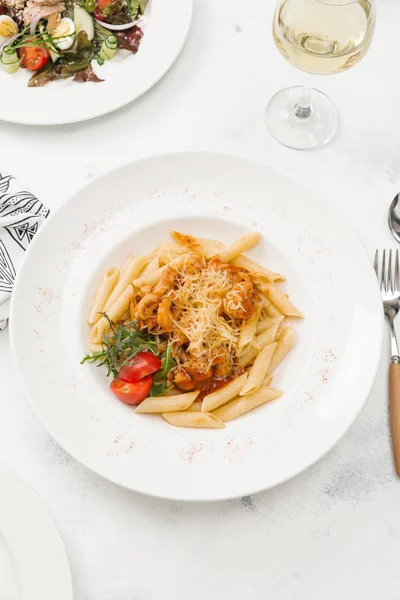 Beyaz tabak içinde sığır eti ve parmesan peynirli taze makarna üstten görünüm
