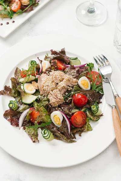 Yeşil Salata tavuk, domates, bıldırcın yumurtası ve beyaz tabakta salatalık ile