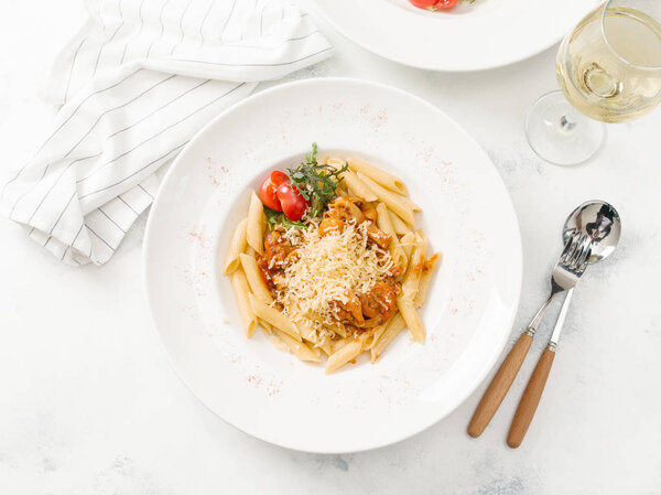Top view of fresh pasta with beef and parmesan cheese in white plate