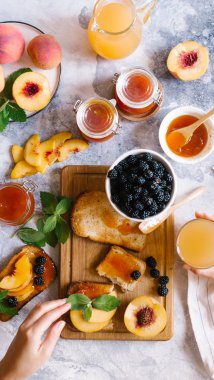 Tost kayısı reçelli ekmek ve beyaz ahşap masa yapraklarda ile taze meyve. Lezzetli kahvaltı.