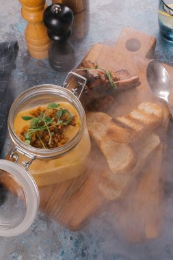 Creme çorbası tost ve duman Ahşap Doğrama tahtası üzerinde kaburga cam