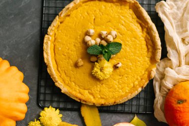 Taş zemin üzerine üstten görünüm taze pişmiş kabak pasta ile fındık ve nane yaprakları