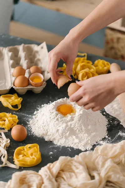 Close view of woman hands making dough for pasta