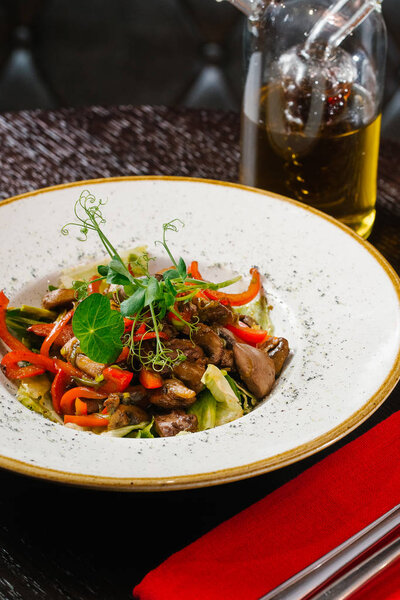 close up view of healthy salad with vegetables and mushrooms served on plate