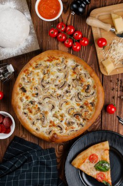 ahşap masa üzerinde beyaz sos, peynir ve dilimlenmiş mantar ile pişmiş pizza üstten görünüm