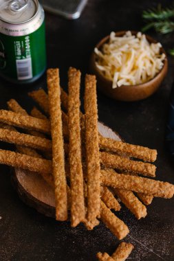 Kızarmış peynirli çubuk karanlık plaka üzerinde