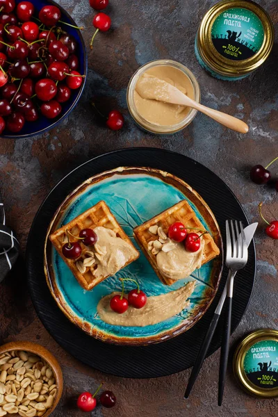 top view of waffles with sweet peanut butter and cherries
