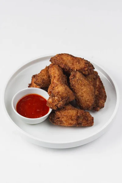 fried chicken pieces with tomato ketchup