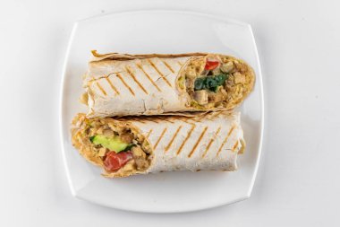 Beyaz tabakta tavuk ve sebzeli shawarma. 