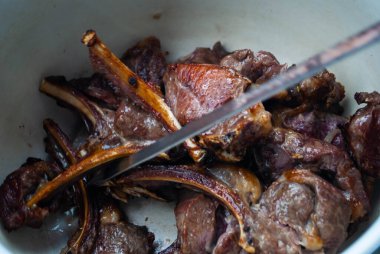 Metal bir şişte barbekü yapmak. Barbeküde ızgara et. Dilimlere kesilmiş taze et şişleri. Geleneksel doğu yemeği, barbekü. Kömür ve alev ızgarası, piknik, sokak yemeği.